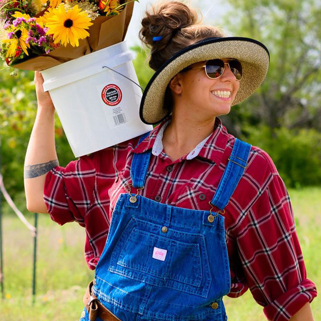 Woman holding a bucket happy.